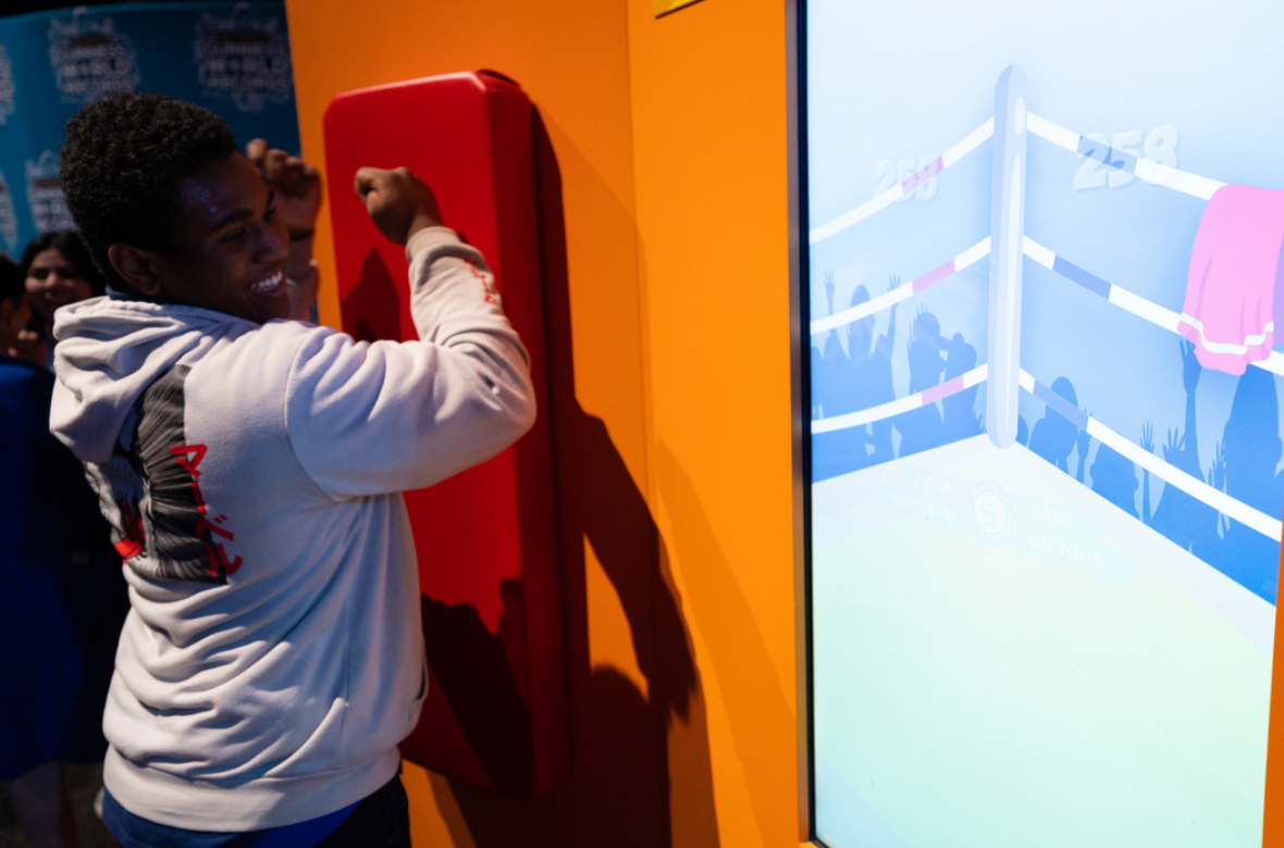 Boy plays boxing game at The Science of Guinness World Records