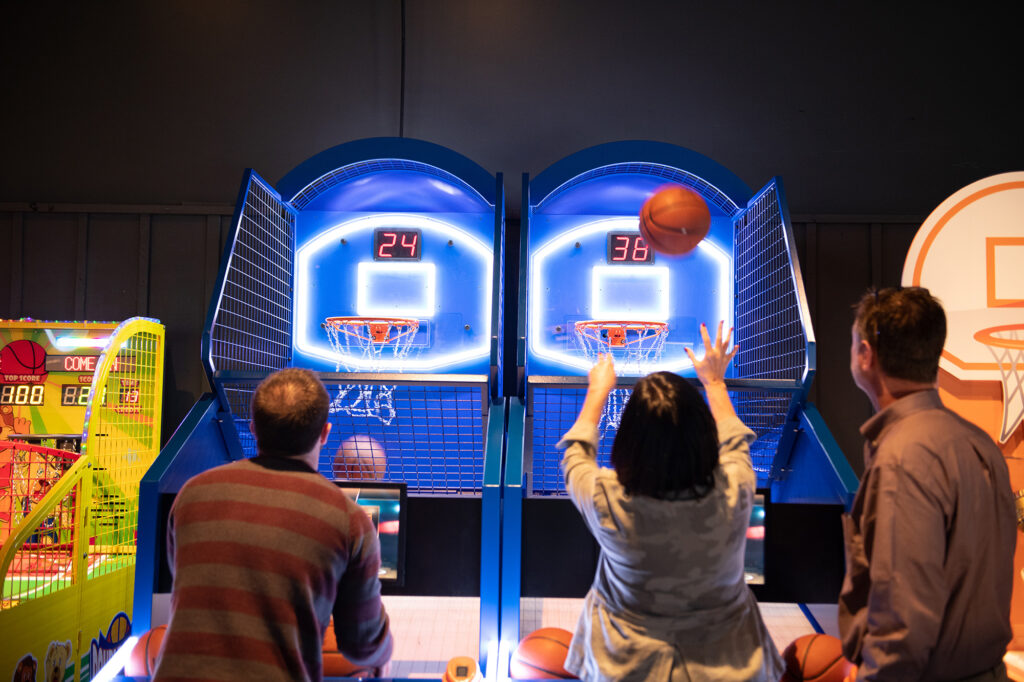 Friends playing arcade basketball at The Science of Guinness World Records