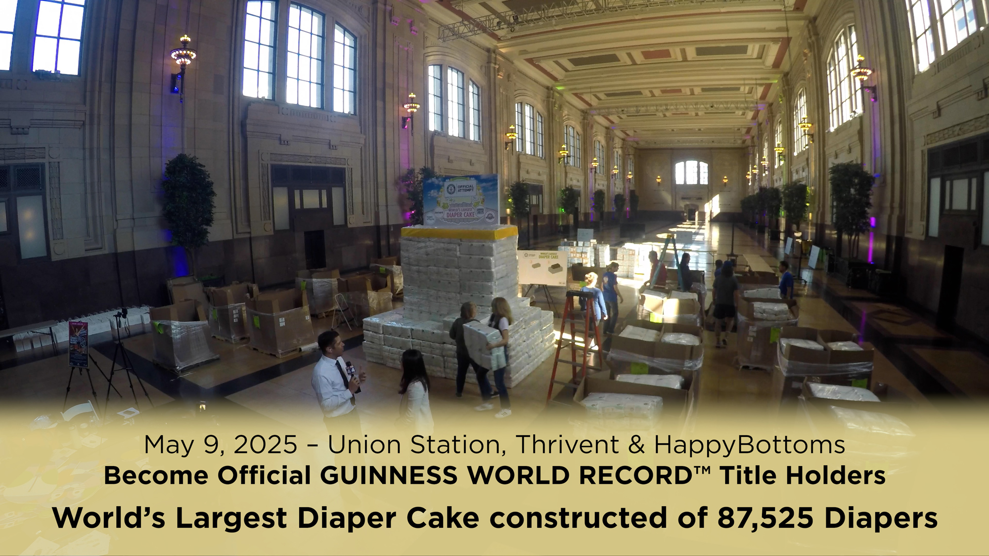 Still image showing the world record setting diaper cake being assembled.