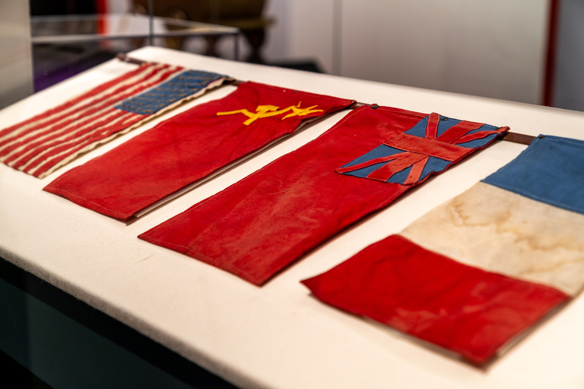 Various small flags on display inside of The Berlin Wall. A World Divided.
