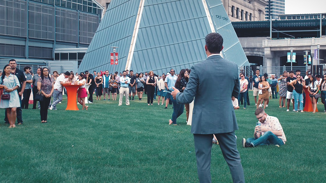 A speaker in Haverty Family Yards while people listen.