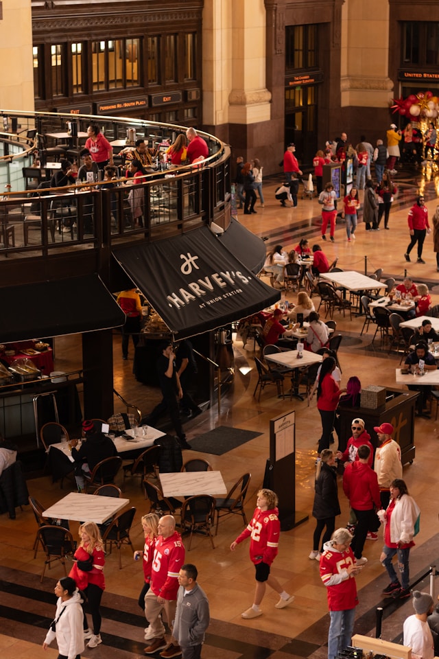 Overhead shot of inside Union Station, overlooking Harvey's with a crowd of Kansas City Chiefs fan walking around.