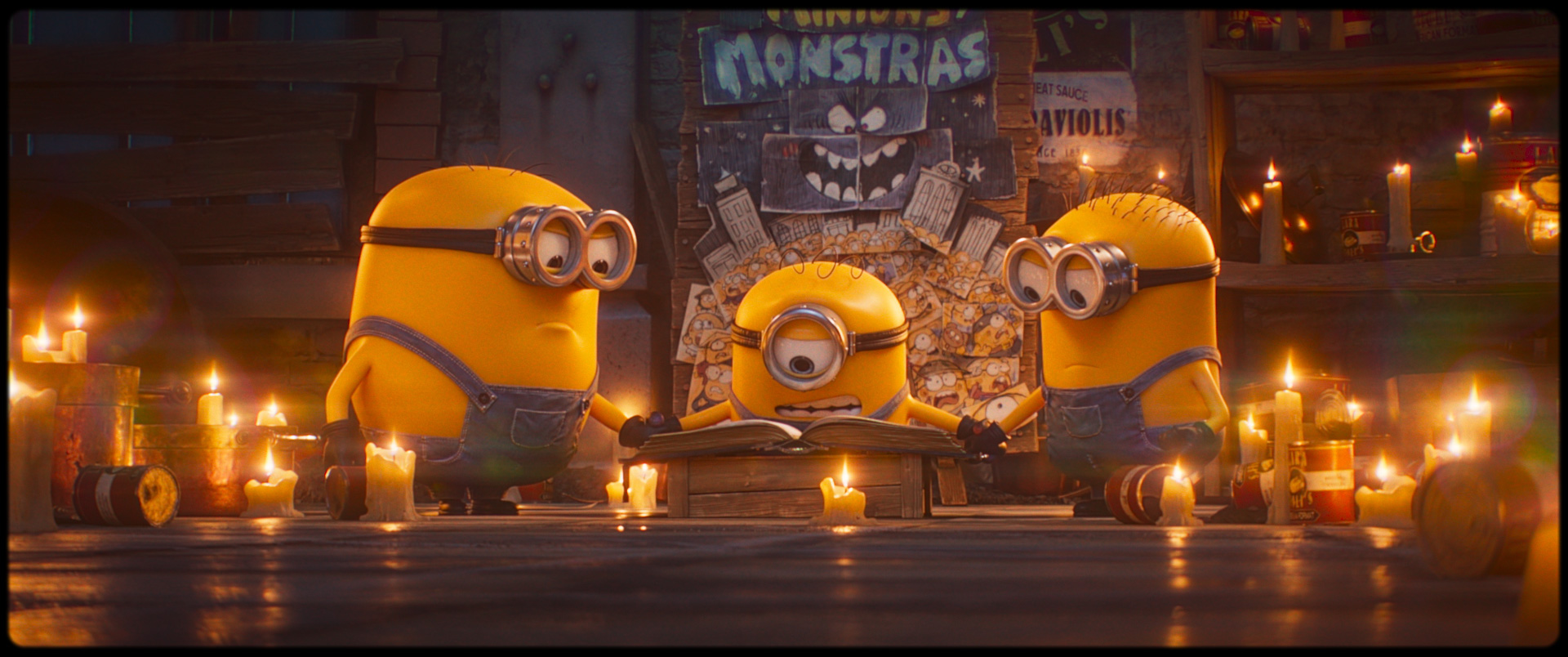 Still image from Minions and Monsters. Featuring 3 of the Minions standing around a book.