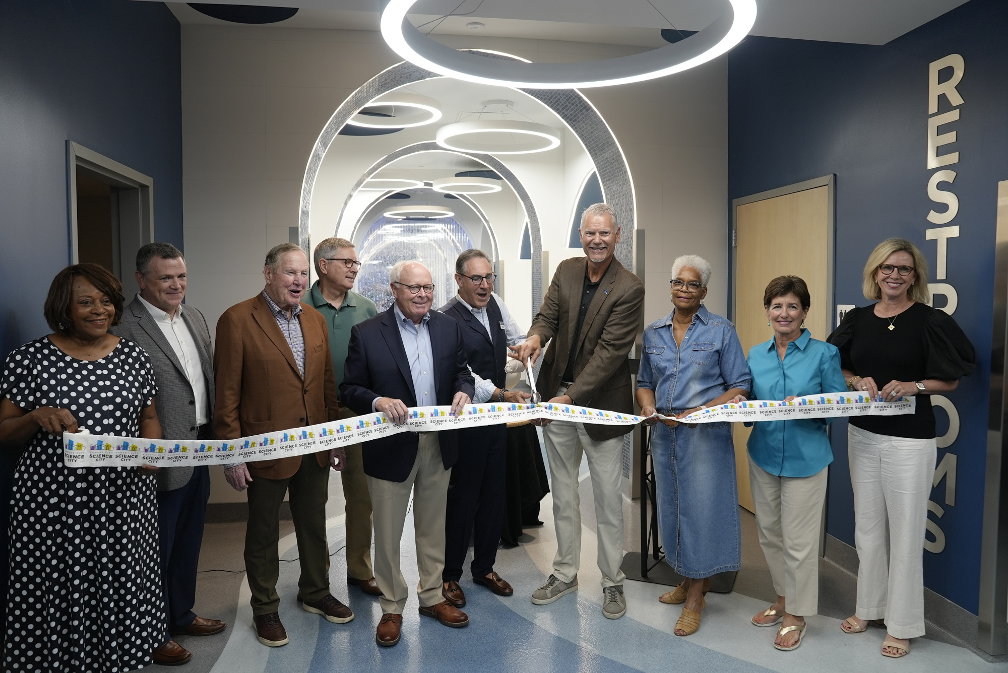 Ribbon cutting for Science City's new bathroom. Featuring various members of Union Station's board and CEO.